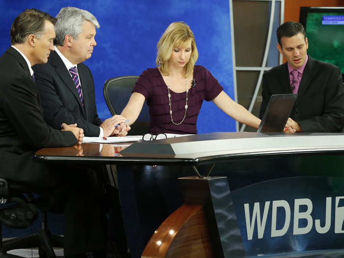 WDBJ-TV7 news crew observe a moment of silence during a newscast for reporter Alison Parker and cameraman Adam Ward who were killed during a live broadcast on August 27, 2015.