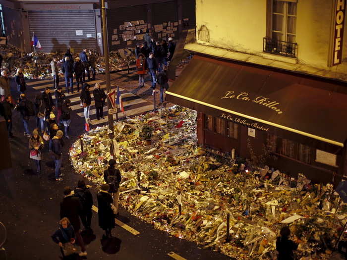 People mourn outside "Le Petit Cambodge" and "Le Carillon" restaurants a week after the Paris attacks.