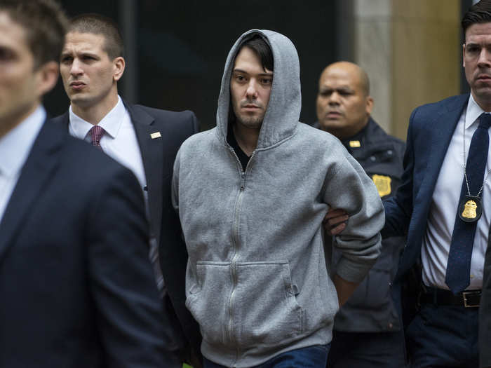 Martin Shkreli, former hedge fund manager under fire for buying a pharmaceutical company and ratcheting up the price of a life-saving drug, is escorted by law enforcement agents on December 17, after being taken into custody following a securities probe.