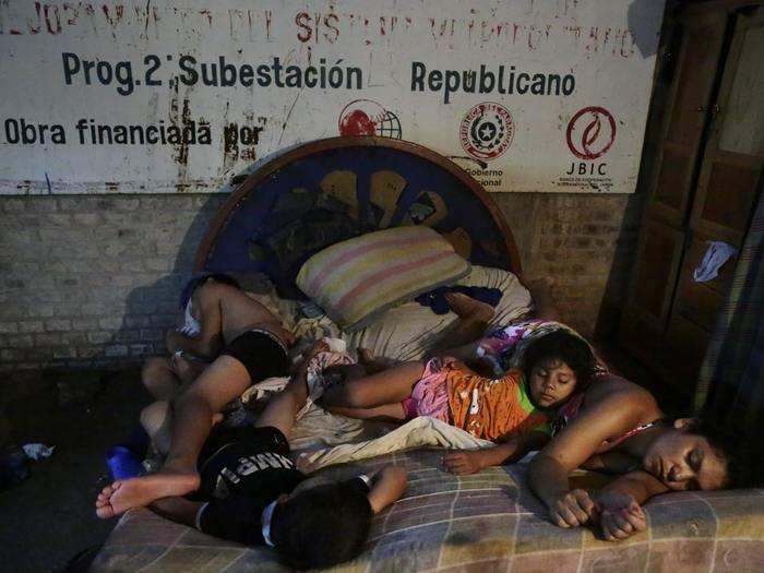 PARAGUAY: Four children from the Saucedo-Rodriguez family sleep on the same bed inside a temporary shelter while their home is flooded in Asuncion, Paraguay, December 23, 2015.