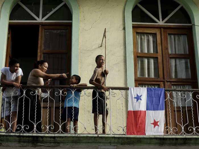 PANAMA: A family watches a Day of the Dead parade from their balcony in the Choriilo neighborhood of Panama City, Monday, November 2, 2015.