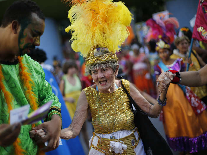 BRAZIL: In this February 12, 2015, file photo, an elderly patient in costume from the Nise de Silveira mental-health institute dances during the institute