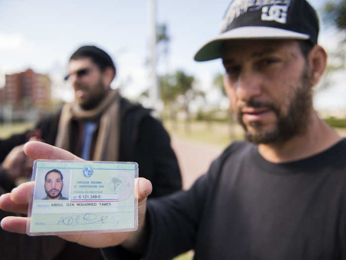 URUGUAY: In this Tuesday, May 6, 2015, photo, freed Guantanamo Bay detainee Adel bin Muhammad El Ouerghi, of Tunisia shows his Uruguayan identification card in front of the US embassy in Montevideo, Uruguay.