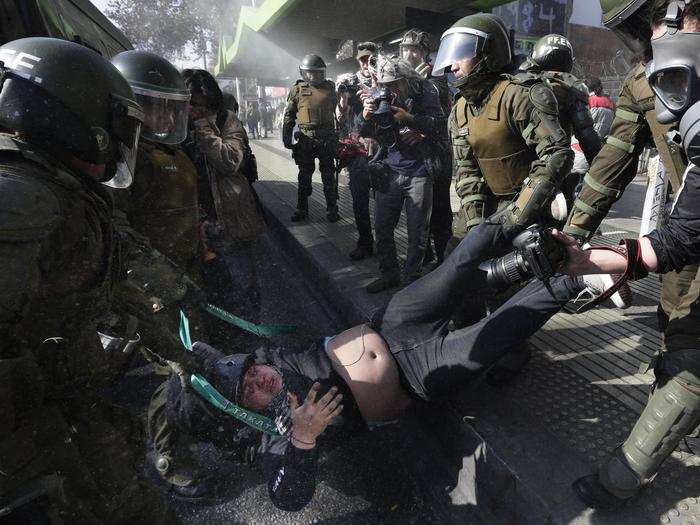 CHILE: A protester is detained by riot police at the end of a march in Santiago, Chile, Thursday, June 25, 2015.