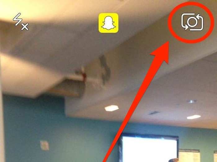 For starters, open the Snapchat app on your phone. If it defaults to the rear camera, click the little camera icon in the upper-right corner to activate the selfie camera.