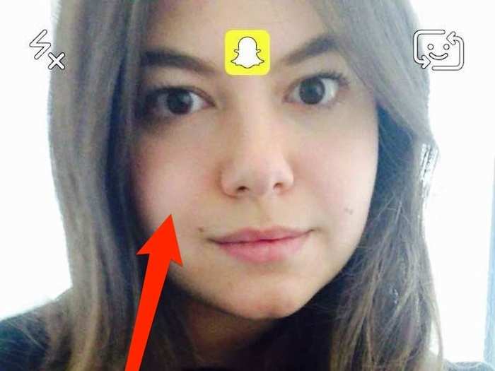 Like many Snapchat features, Lenses is not very intuitive or obvious to use. Once you have the camera pointed to you, tap on your face for a couple seconds to turn on Snapchat