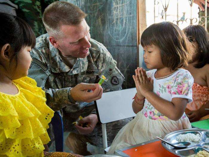 February 3: U.S. Army Capt. Ryan Mortensen, a chaplain assigned to 1st Battalion, 27th Infantry Regiment, 2nd Stryker Brigade Combat Team, 25th Infantry Division, interacts with children of the Middle Mosque of Lop Buri, Thailand. Cobra Gold 15 allows U.S. Soldiers to bond with the Thai community, continuing a 182-year tradition of friendship.