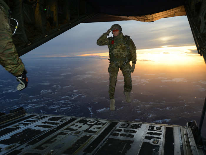 February 24: A U.S. Army Soldier, assigned to 1st Battalion, 10th Special Forces Group (Airborne), salutes his fellow Soldiers while jumping out of a C-130 Hercules aircraft over a drop zone in Germany.