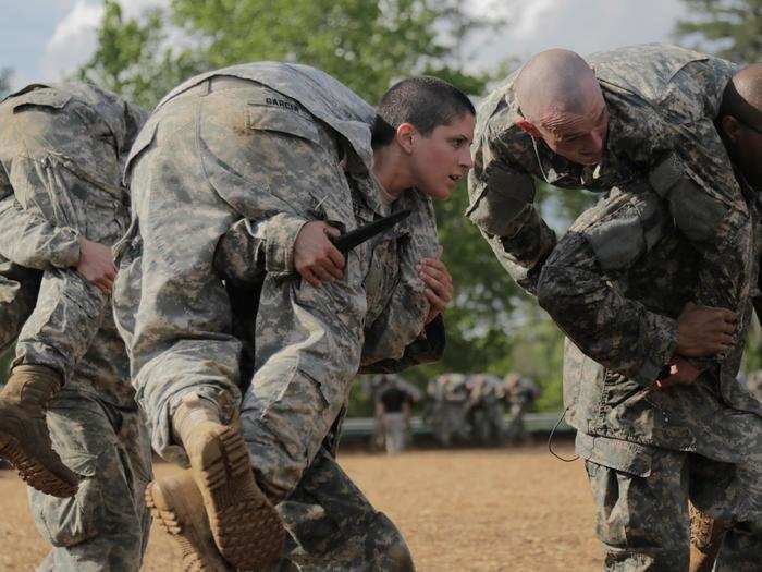 April 20:  U.S. Army Capt. Kristen Griest, middle, carries a fellow Soldier as part of combative training during the Ranger Course on Fort Benning, Ga. Nineteen female Soldiers made history, April 20, when they began the first gender-integrated Ranger Course assessment.