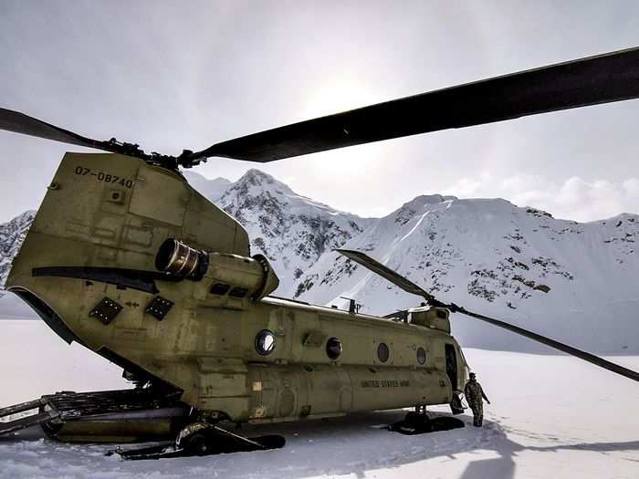 April 27: A U.S. Army Soldier from D Company, 1st Battalion, 52nd Aviation Regiment stands outside a CH-47F Chinook helicopter at the Kahiltna Glacier base camp on Mount McKinley, Alaska.