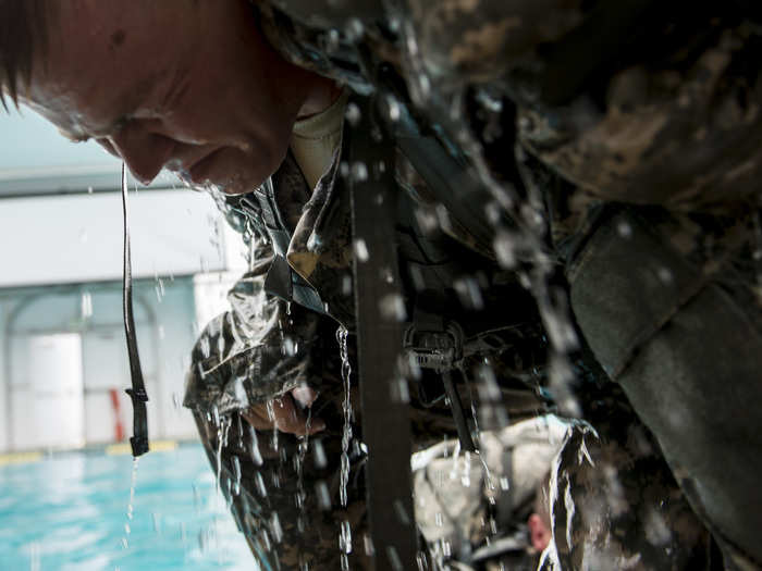 July 17: A U.S. Army Reserve combat engineer Soldier, from the 374th Engineer Company (Sapper), tries to stand up with a loaded ruck sack full of water during Combat Water Survival Training at Fort Hunter Liggett, Calif.