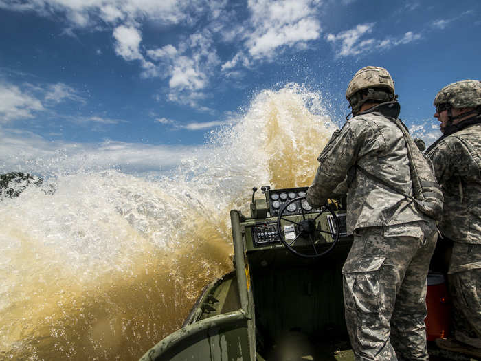 July 31: A wave splashes onto an MK-2 Boat operated by U.S. Army Reserve Soldiers Staff Sgt. Chad Bentley, bridge crew member, and Spc. Ben Adams, medic, from 341st Engineer Company (Multi-Role Bridge), during a sling loading operation on the Arkansas River near Fort Chaffee. Soldiers from various Army Reserve and active duty units trained together at River Assault, a bridging training exercise that involves Army Engineers and other support elements.