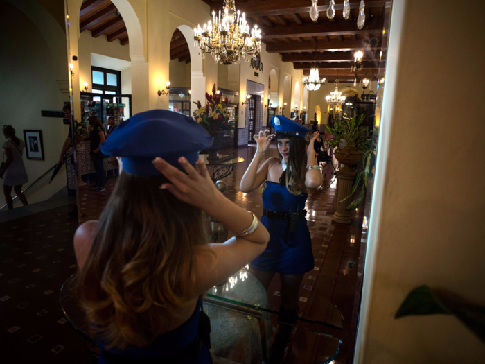 The girls often wear elaborate ensembles. Here, Yuaniley Dopico Martinez, who lives in Cuba, takes part in a photo shoot at the National Hotel in Havana. More families have increased income to spend on quinceañeras due to recent economic reforms.