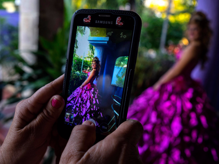 Amanda Teresa Betancur also lives in Cuba and can be seen here in a more traditional quinceañera outfit. Over the years, quinceañera photos have featured girls in puffy dresses and crowns.