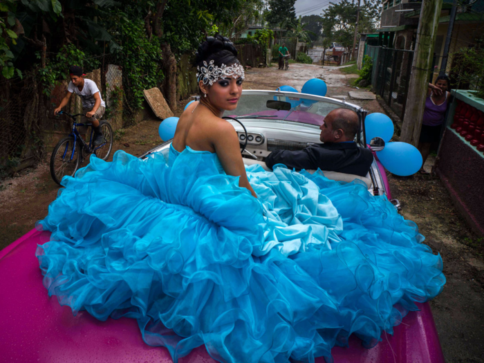 Torres also waits in a convertible with her father to head to the event in Punta Brava, which is located near Havana.