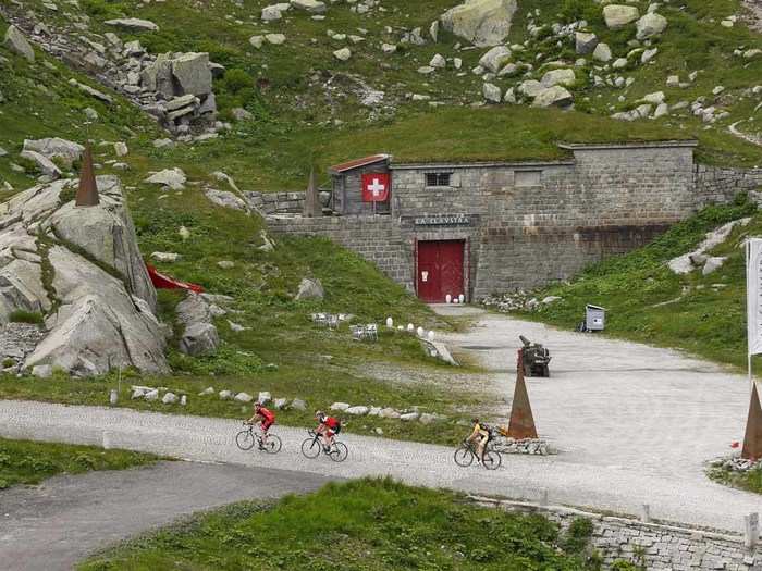 Cyclists spin right past the Hotel La Claustra, hidden in its former bunker home.