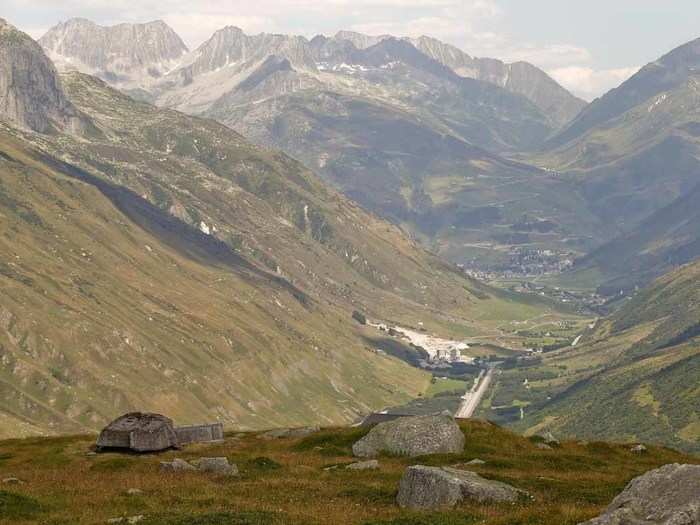 The Urserental Valley spreads out below a camouflaged canon at the Fuchsegg artillery fortress near the village of Realp. The Fuchsegg fortress, situated in the central Swiss Alps, was built in 1943 and remained in military use until 1993.