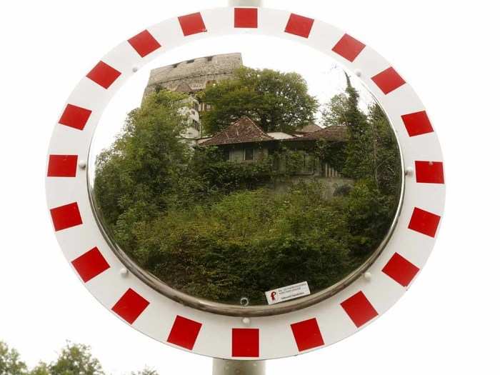 A former infantry bunker near the town of Duggingen masquerades as a medieval house, reflected here in a roadside mirror.