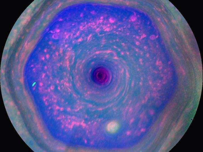 The bizarre shape of this giant storm, shown below in false-color, might come from columns of clumped gas spinning at different speeds. Scientists have made similar spinning hexagons this way using water in labs on Earth.