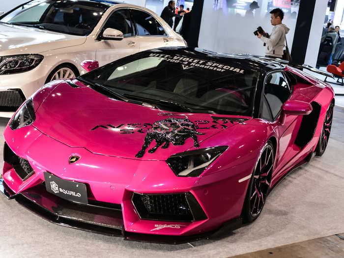 A Barbie pink Lamborghini Aventador is painted with a bull for the 2015 auto show.