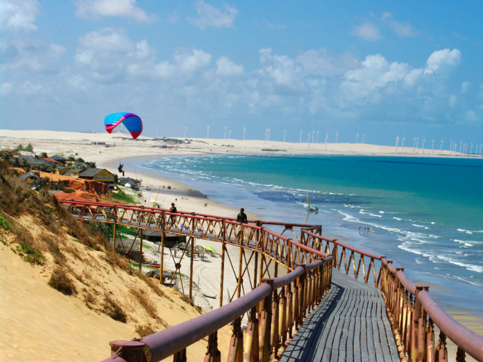 Praia do Canoa Quebrada, in northeastern Brazil, is a beach just off of a small fishing village where golden sand dunes slide into blue waters. Sip on fresh agua de coco while sunbathing, go sandboarding in the dunes, or try out windsurfing.