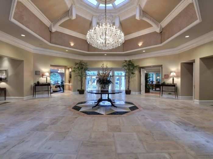 The grand entrance rotunda is anchored by an ornate crystal chandelier.