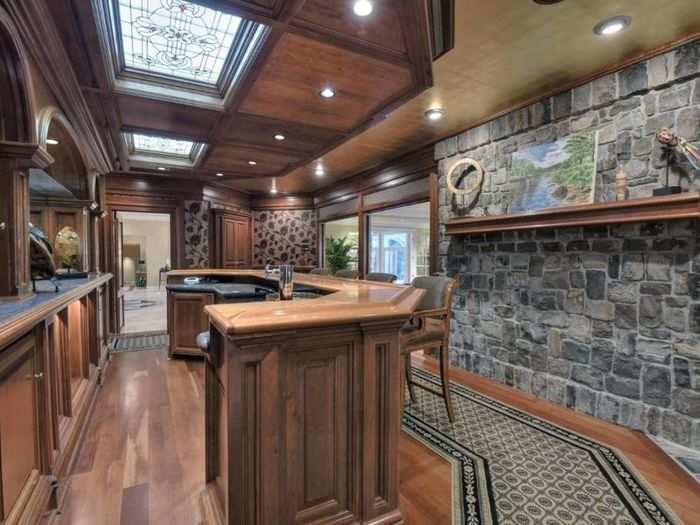 This bar area has skylights and an indoor rock wall that gives it a rustic edge.