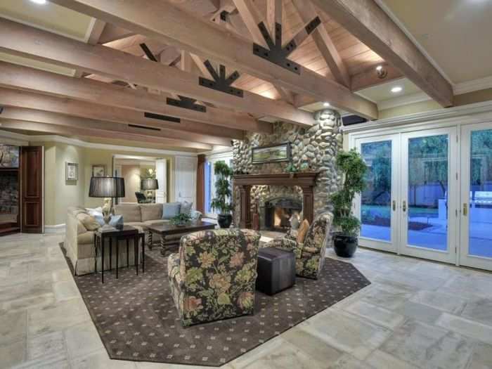 Exposed, light-wood beams add a cozy accent to the family room.