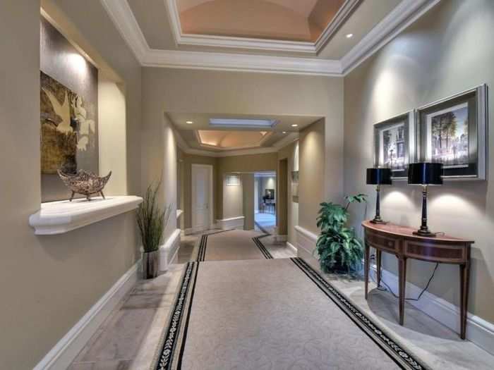 A long hallway in the home most likely leads to some of the eight bedrooms.