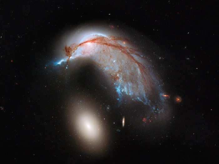 And a different set of galaxies in which one of the galaxies has been stretched and warped by the other galaxy