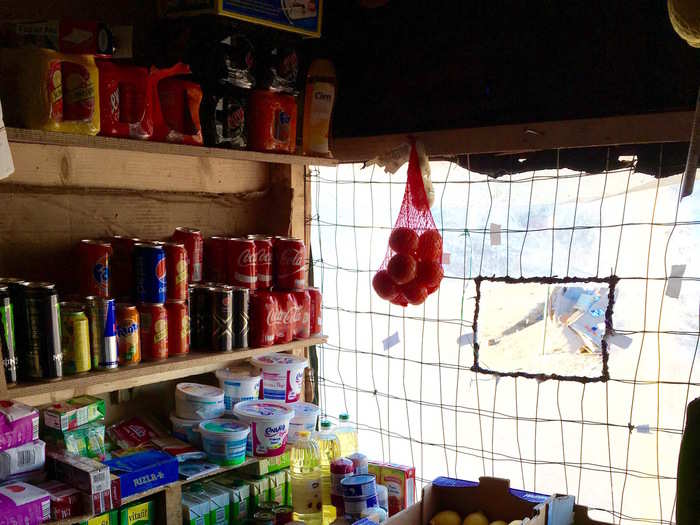 As the camp grows, it has also developed a variety of businesses — here is the inside of one of the many grocery stores in the Jungle, which doubles as a restaurant.