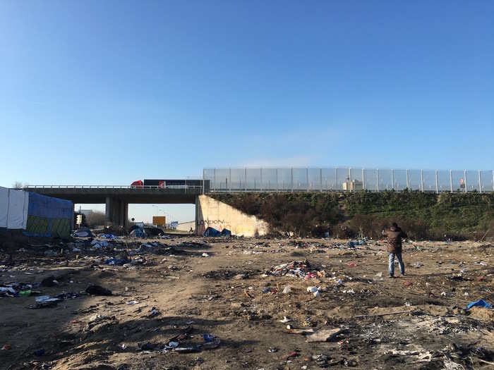 A truck is passing on the stretch of the motorway that is closest to the camp. From there many refugees tried to get into lorries to get transported to the UK.