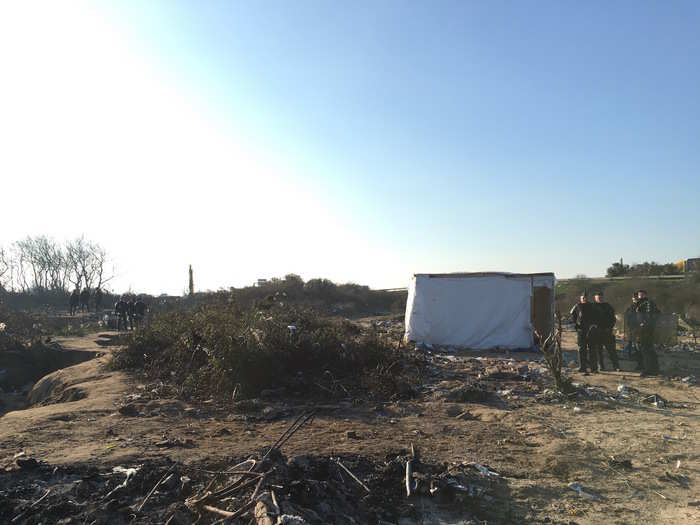 The last standing shelter in the "eviction" zone is guarded by police after they told the three men who were sleeping inside to leave.