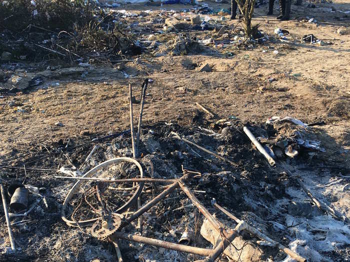 The remains of a bicycle that was burned in one of the many camp fires lit the night before the authorities came in with bulldozers.