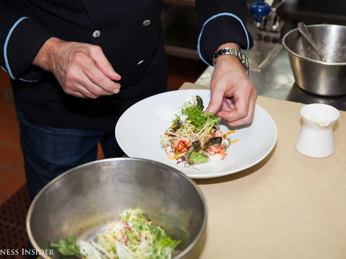 Each piece of seafood is carefully plated one by one before the avocado is added in. Finally, Portale will add some fresh frisée in and around the dish, and add a bit more dressing to the top. The dish is incredibly fresh, yet rich, with large portions of seafood that give a hearty bite alongside a bit of tartness to the dressing to maintain flavor.