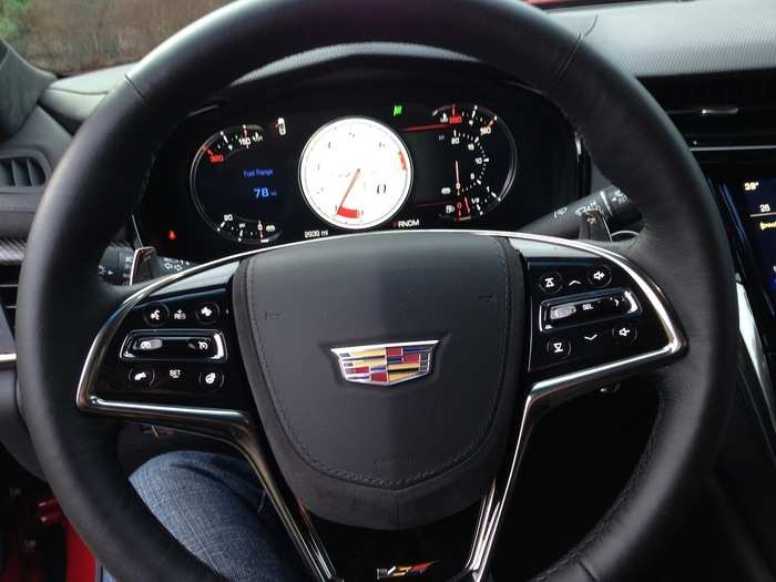 This is Sport mode. A little green checkered-flag icon has appeared, and the tachometer has turned white.