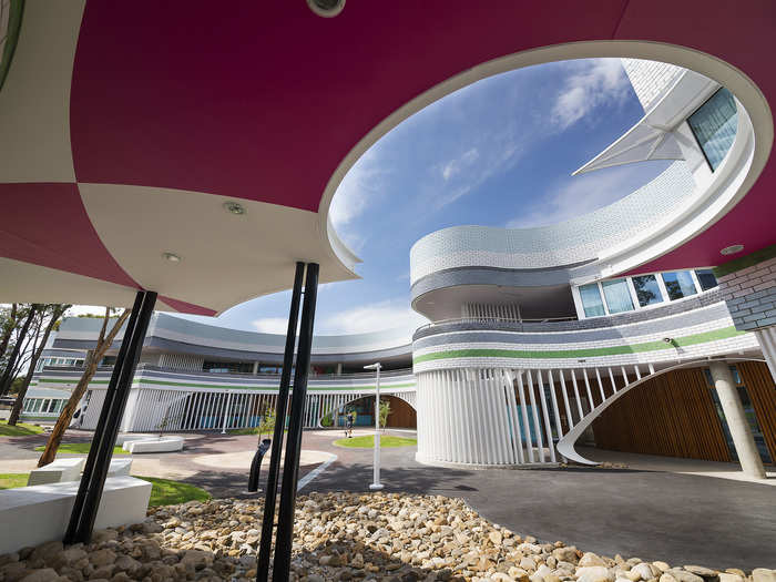 In Niddrie, Australia, the Penleigh and Essendon Grammar School features a jester-like color scheme. Sloping walls give the building a playful feel.