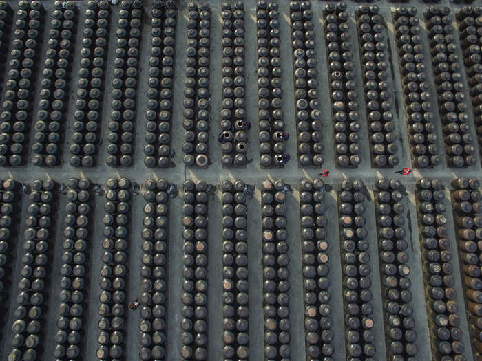 Workers navigate a huge vinegar and soy sauce mill in Zhenjiang, Jiangsu province.