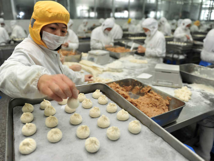 A worker makes stuffed steamed buns at a food factory in Yangzhou, Jiangsu province.