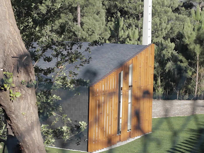 The back side of the house is also finished in wood, helping it blend in with its surroundings.