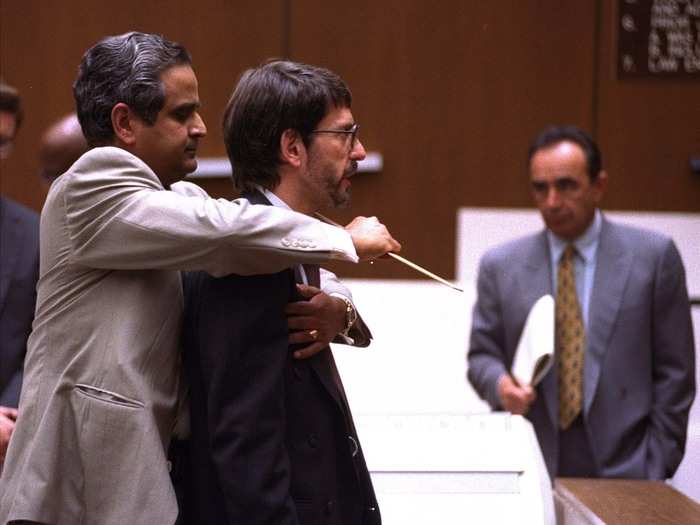 Dr. Lakshmanan Sathyavagiswaran, the LA county coroner, demonstrates on prosecutor Brian Kelberg how Ronald Goldman