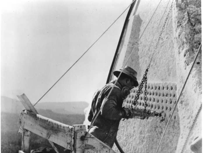 After controlled blasting, workers used jackhammers to honeycomb the granite. This weakened the remaining rock enough that  three to six inches of rock could be removed by hand to reveal the final carving surface.