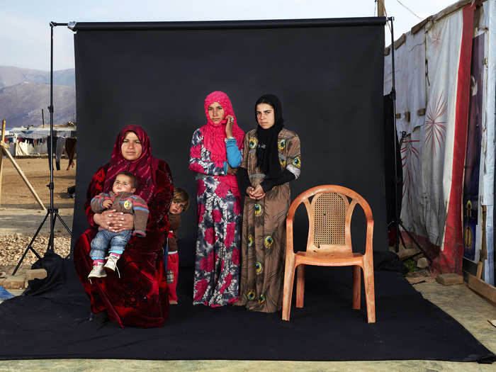 People Singles, 3rd prize: Dario Mitidieri, Italy — Portrait of a Syrian refugee family in a camp in Bekaa Valley, Lebanon, on 15 December 2015. The empty chair in the photograph represents a family member who has either died in the war or whose whereabouts are unknown.