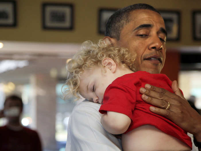 A sleepy young Iowan rests his head on the president