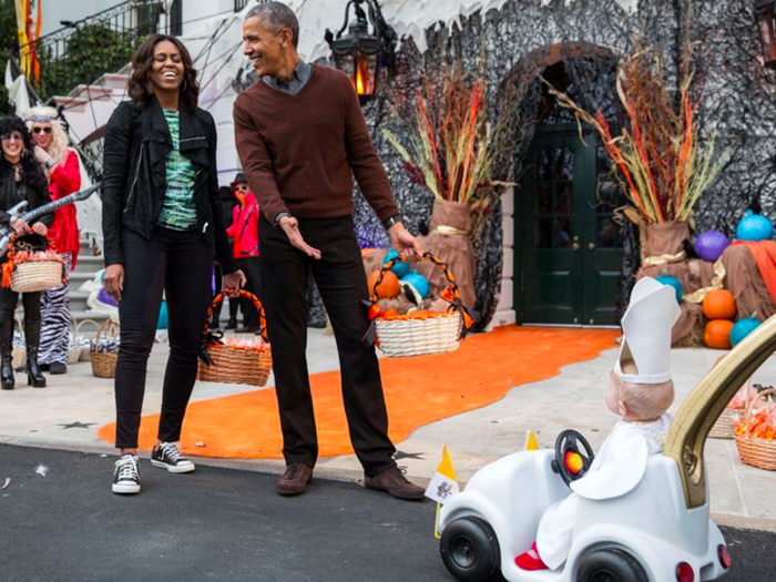 The Obamas laugh at a child dressed as the pope.