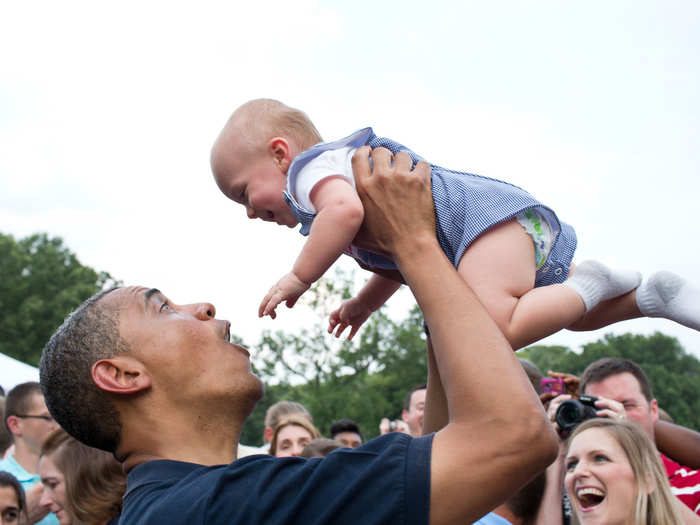 Obama hoists his young pal Simba-style.