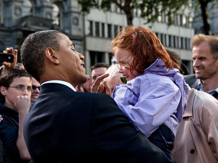 The president embraces a young girl during a 2011 visit to Ireland.