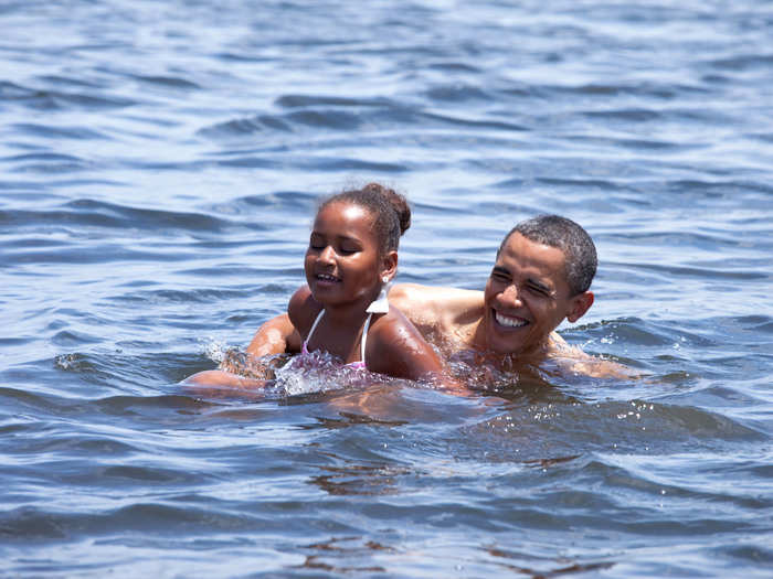 Sasha and her father splash around in the ocean on a vacation to Florida.