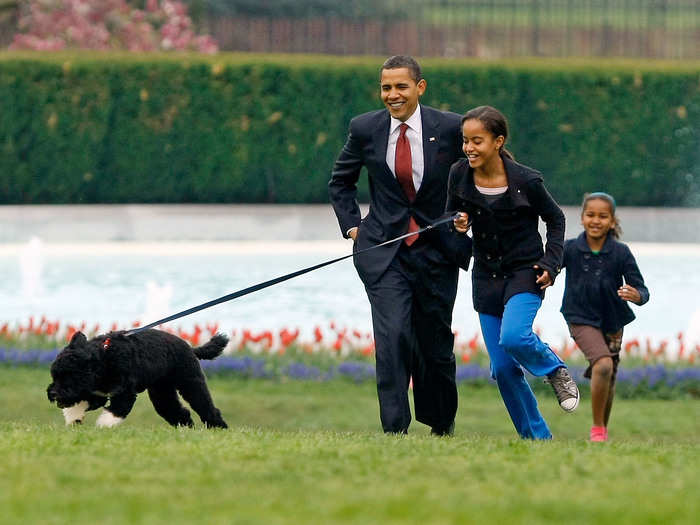 The president and his daughters celebrate the arrival of Portuguese Water Dog Bo.