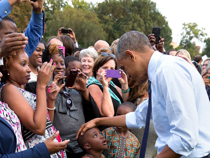 Obama says hello to a set of twins on the South Lawn.